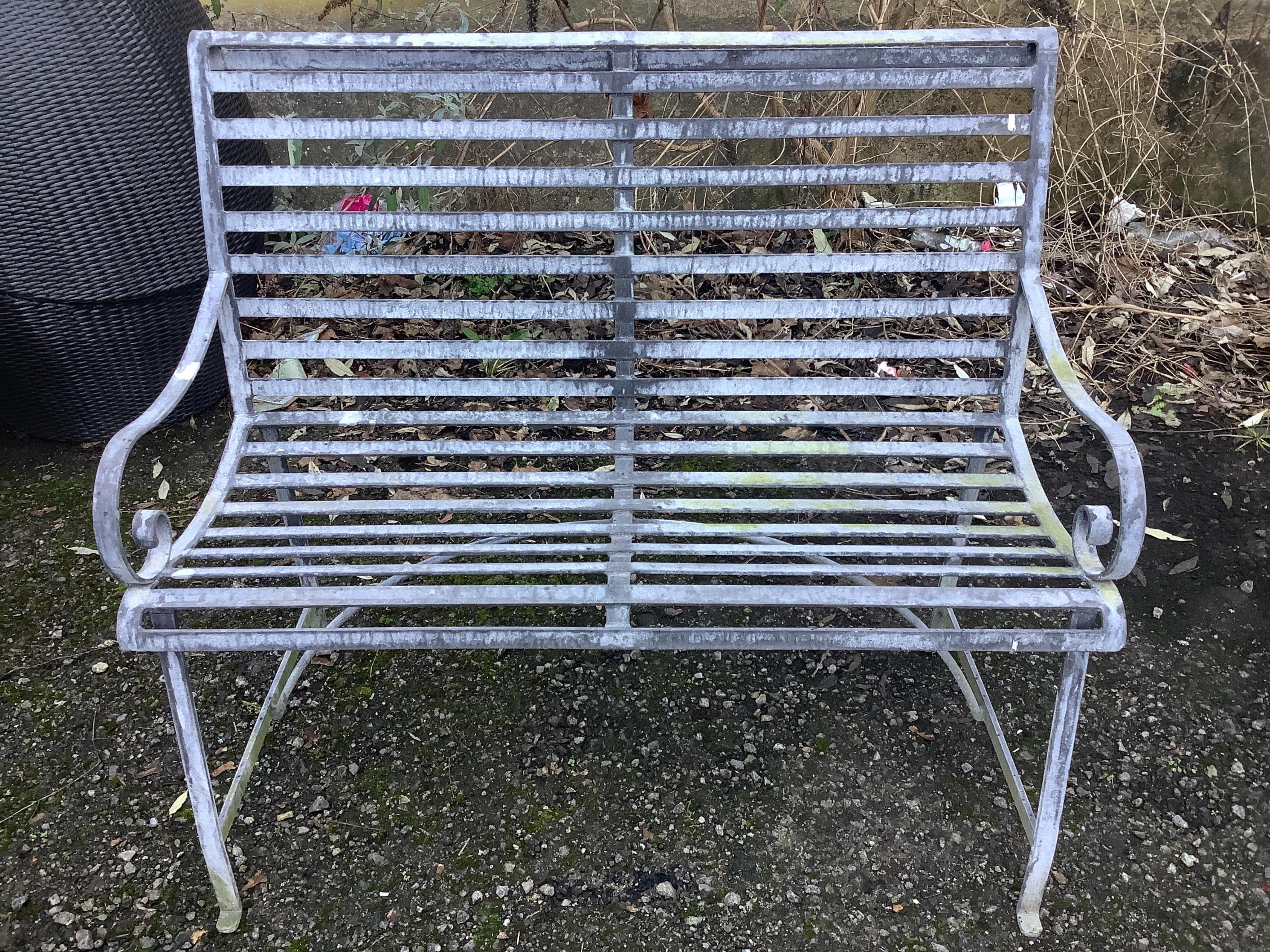 A 19th century style slatted wrought iron garden bench, width 107cm, depth 42cm, height 94cm. Condition - fair to good